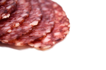 Salami sausage slices isolated on white background.