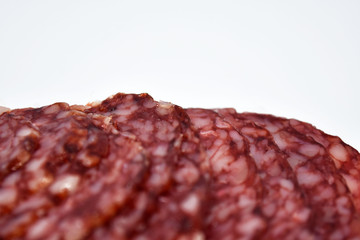 Salami sausage slices isolated on white background.
