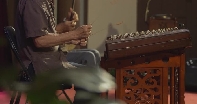 side view Close up of two senior Chinese man playing Erhu traditional Chinese two-stringed bowed music instrument and dulcimer on the stage