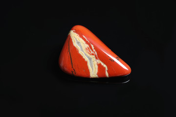 Beautiful red and white jade gemstone on black background