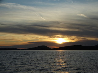 Fototapeta premium golden hour beautiful colors cloudy sunset horizon above sea at evening igoumenitsa city greece
