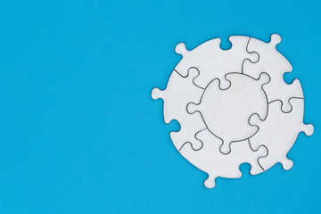 White jigsaw pieces on a blue background, Copy space, Concept image of unfinished task.  missing...