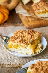 Piece of grated pumpkin pie on a white plate 