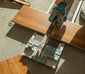 A professional cutting ceramic tiles with a ceramic knife. 