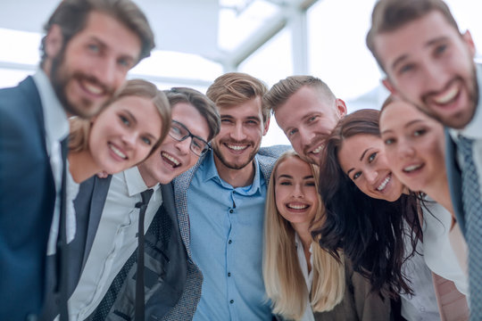 close up.a team of young business people looking at the camera.