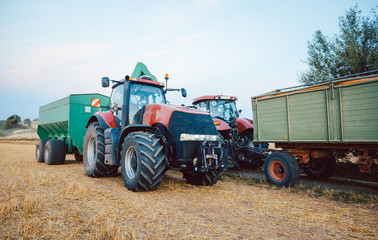 Agricultural machinery and tractor on a harvested field