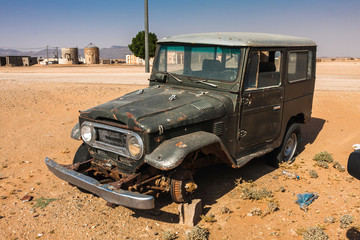 An abandoned vintage car in an unnamed small settlement near the Makkah Al Mukarramah Road
