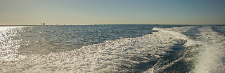 Obraz premium Sea waves splashing, yacht track, Summer vacation at the sea