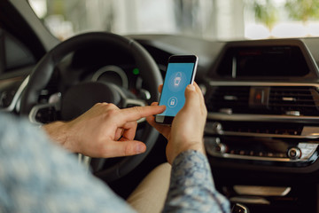 Man using smartphone app to pay for the parking. Internet payment online with modern device, smartphone screen. 