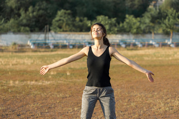 A young slim athletic girl in sportswear performs a set of exercises. Fitness and healthy...