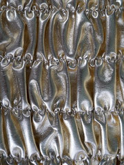  Silver  shirred background. Metallic shiny material. Detail, background. Close up, texture,