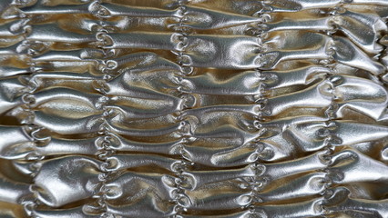  Silver  shirred background. Metallic shiny material. Detail, background. Close up, texture,