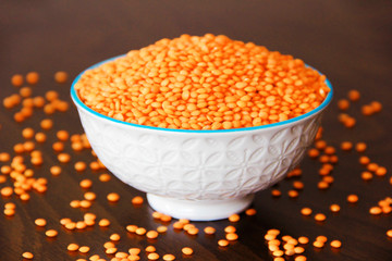 orange dry small oriental lentil groats in a ceramic white plate