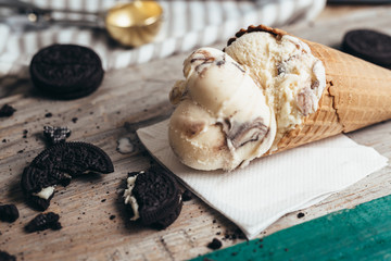 delicious ice cream in cone on wooden table