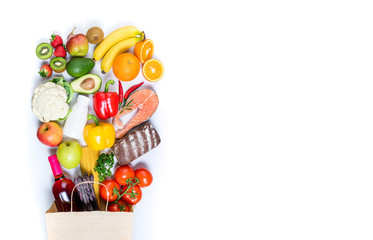 Shopping healthy food in paper bag fish, pasta, vegetables, fruits and wine on white background....