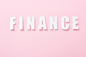 top view of white finance inscription on pink background