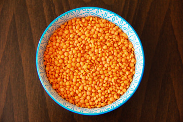 orange dry small oriental lentil groats in a ceramic white plate