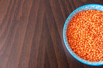 orange dry small oriental lentil groats in a ceramic white plate
