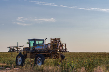 Crop Sprayer in Field at Sunset