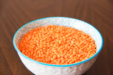 orange dry small oriental lentil groats in a ceramic white plate