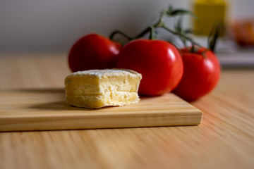 Still life with three tomatoes and french cheese