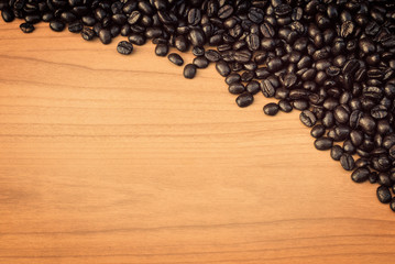 Fototapeta premium Coffee beans on wood texture background 