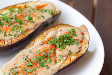Oven roasted eggplant with vegan tahini sauce, ghost pepper powder and parsley
