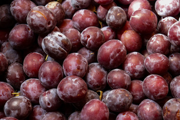 Fresh juicy black plums for background