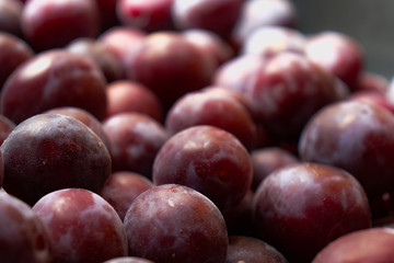 Fresh juicy black plums for background