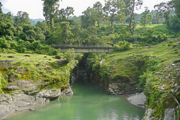 Fototapeta na wymiar Bridge over a mountian stream