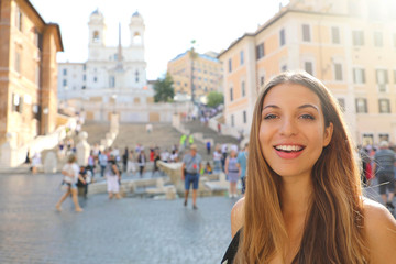 Obraz na płótnie Canvas Close up of beautiful cheerful woman in Piazza di Spagna square in Rome with Spanish Steps and Barcaccia fountain on the background