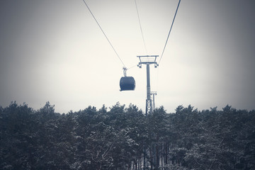 funicular in bad weather stuck over the forest. Rescue of people.