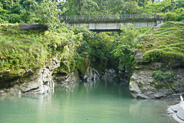 Fototapeta na wymiar Bridge over a mountian stream