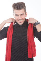 young handsome man in black sweater and a red scarf