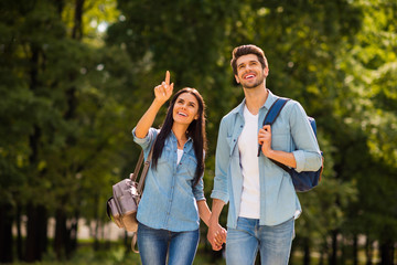Fototapeta premium Photo of charming pair walking green sunny day observing sightseeing wear denim outfit