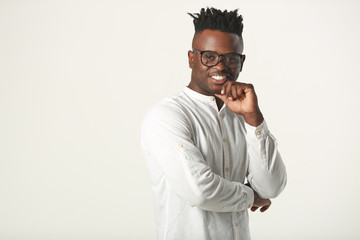 handsome young african man in glasses and white shirt on a white background