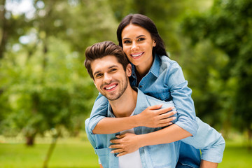 Fototapeta premium Photo of cute pair having fun together walking summer green park outdoors wear denim outfit