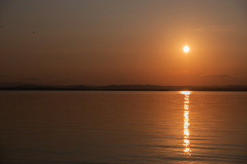 Fototapeta na wymiar Incredible sunset on the background of a mountain lake