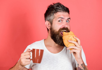 Delicious breakfast. Man start morning with coffee and croissant. Bearded hipster enjoy breakfast...
