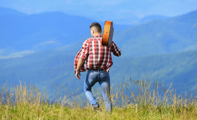 dont look back. sexy man with guitar in checkered shirt. hipster fashion. western camping and hiking. happy and free. cowboy man with acoustic guitar player. country music song