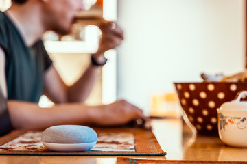 Smart ai speaker. Smart home concept with man eating in the background