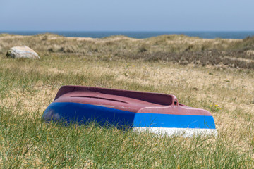 Rowing boat abandoned in the sand dunes