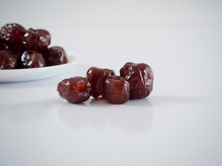 Jujube in syrup on a white plate