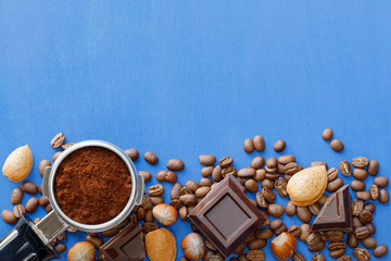 Coffee, chocolate and nuts on a blue background