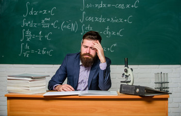 Decreased energy level. Tired teacher in class. Bearded man suffer from headache. Being tired of...