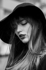 Adorable girl wears hat and suit. Outdoor shot