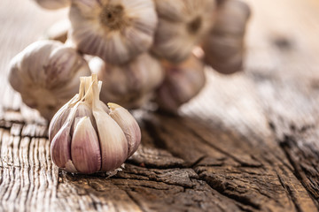 Garlic cloves and bulb old wooden table