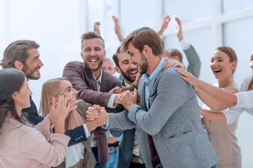 corporate group of employees applauding their colleague.
