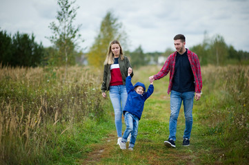 a young family walks on a country side