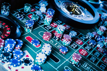 Roulette table and stack of poker chips. Casino, gambling and entertainment concept.